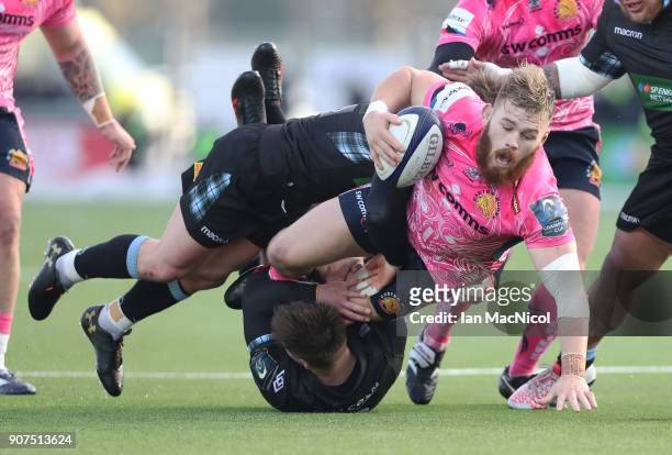 Luke Cowan-Dickie of Exeter Chiefs is tackled by Peter Horne of Glasgow Warriors during the European Rugby Champions Cup match between Glasgow...