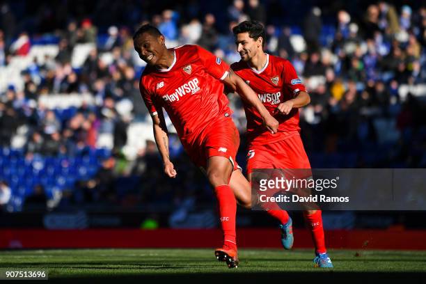 Luis Muriel of Sevilla FC celebrates with his team mate Jesus Navas after scoring his team's third goal during the La Liga match between Espanyol and...