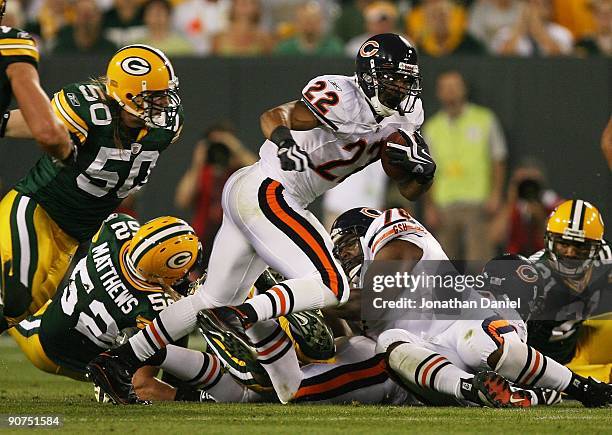 Matt Forte of the Chicago Bears tries to gain yardage as A.J. Hawk of the Green Bay Packers chases him on September 13, 2009 at Lambeau Field in...