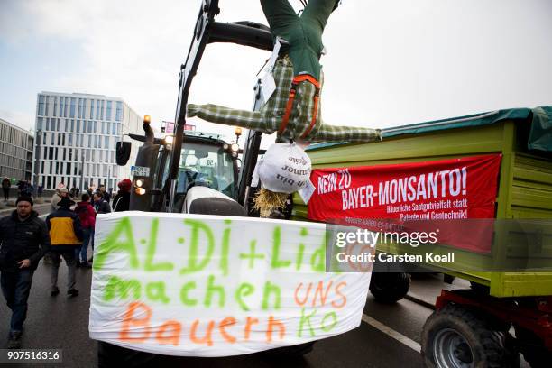 Protesters show a banner with the slogan "Aldi+Lidl knock us out" attached to a tactor during a march to demonstrate against the agro-industry on...