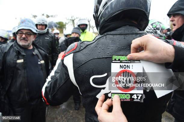 Biker bears a sticker during a demonstration against the 80km/h speed limit on January 20, 2018 in Agen, southern France. The French government...