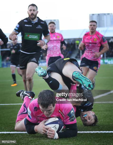 George Horne of Glasgow Warriors fails to stop Ian Whitten of Exeter Chiefs scoring his team's third try during the European Rugby Champions Cup...