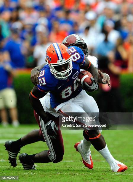 Omarius Hines of the Florida Gators runs for yardage during game against the Troy Trojans at Ben Hill Griffin Stadium on September 12, 2009 in...