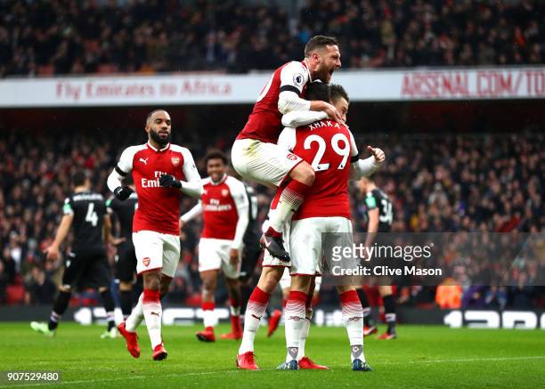 Laurent Koscielny of Arsenal celebrates after scoring his sides third goal with Granit Xhaka of Arsenal and Shkodran Mustafi of Arsenal during the...