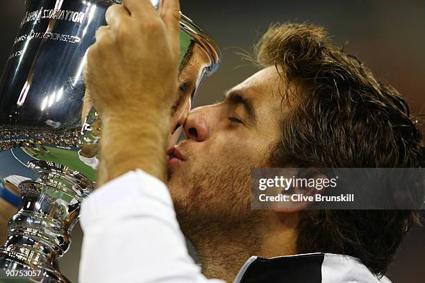 Juan Martin Del Potro of Argentina kisses the championship trophy after defeating Roger Federer of Switzerland in the Men's Singles final on day...