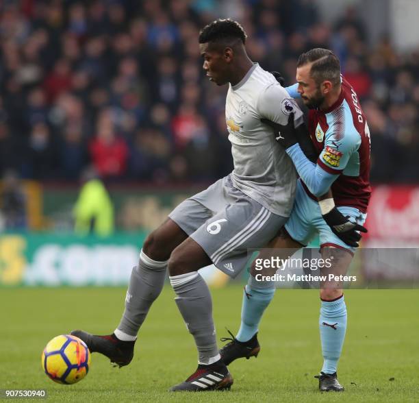 Paul Pogba of Manchester United in action with Steven Defour of Burnley during the Premier League match between Burnley and Manchester United at Turf...