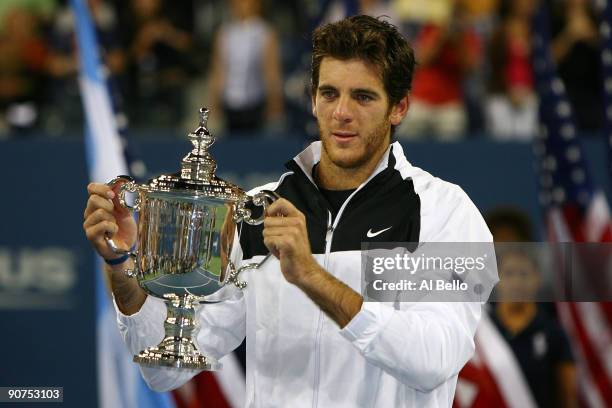 Juan Martin Del Potro of Argentina holds the championship trophy after defeating Roger Federer of Switzerland in the Men's Singles final on day...