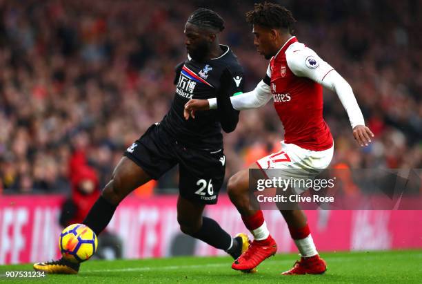 Bakary Sako of Crystal Palace is challenged by Alex Iwobi of Arsenal during the Premier League match between Arsenal and Crystal Palace at Emirates...