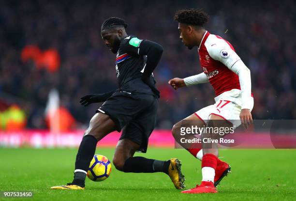 Bakary Sako of Crystal Palace is challenged by Alex Iwobi of Arsenal during the Premier League match between Arsenal and Crystal Palace at Emirates...