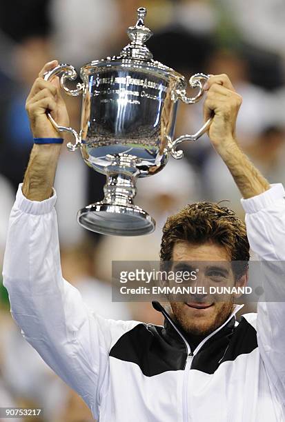 Tennis player Juan Martin Del Potro from Argentina holds his trophy after beating Roger Federer from Switzerland during the final of the 2009 US Open...