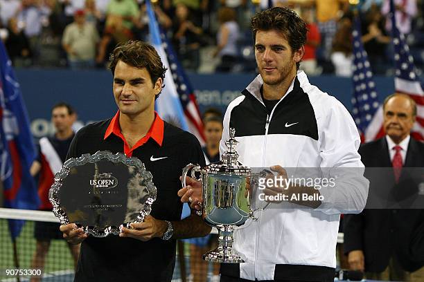 Roger Federer of Switzerland and Juan Martin Del Potro of Argentina pose with their trophies after the Men's Singles final on day fifteen of the 2009...