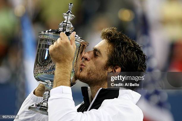 Juan Martin Del Potro of Argentina kisses the championship trophy after defeating Roger Federer of Switzerland in the Men's Singles final on day...