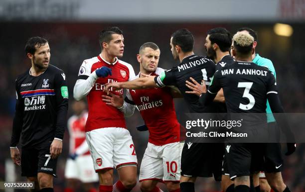 Granit Xhaka and Jack Wilshere of Arsenal clash with Luka Milivojevic and James Tomkins of Crystal Palace and during the Premier League match between...