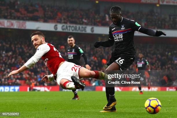 Shkodran Mustafi of Arsenal attempts to tackle Bakary Sako of Crystal Palace during the Premier League match between Arsenal and Crystal Palace at...