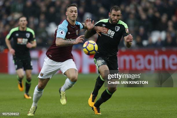 West Ham United's Austrian midfielder Marko Arnautovic vies with Bournemouth's English defender Steve Cook during the English Premier League football...