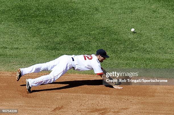 Nick Green of the Boston Red Sox misses a ground ball at shortstop during the game against the Oakland Athletics at Fenway Park on July 30, 2009 in...