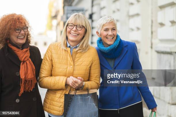 three mature women out in shopping - friends shopping stock pictures, royalty-free photos & images
