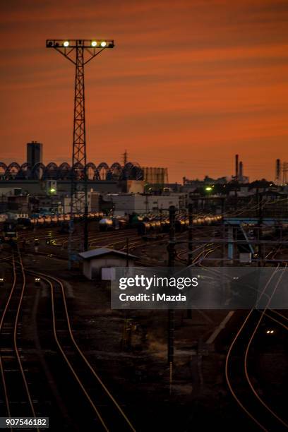 at the base of a freight train, at the sunset. - train yard at night stock pictures, royalty-free photos & images