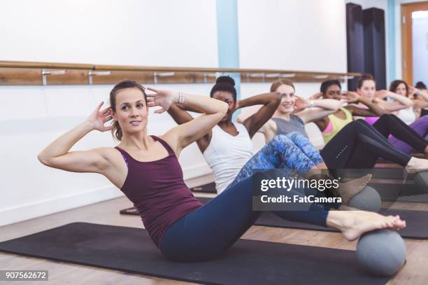 women working out together at modern gym - floor gymnastics stock pictures, royalty-free photos & images