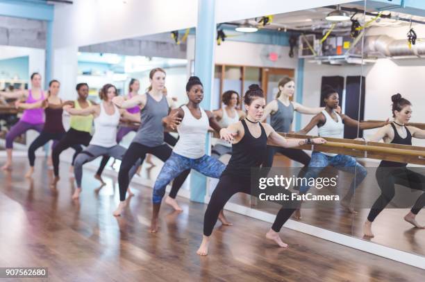 women doing barre workout together at modern gym - hesitant to dance stock pictures, royalty-free photos & images