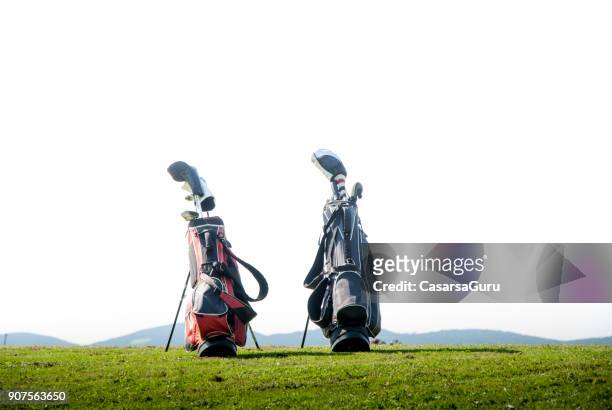 two golf bags on meadow - golf bag stock pictures, royalty-free photos & images