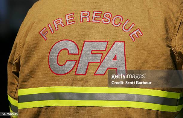 The CFA logo is seen on a firefighters uniform as firefighters take part in the "More Firefighters Not Less Rally" at Parliament House on September...