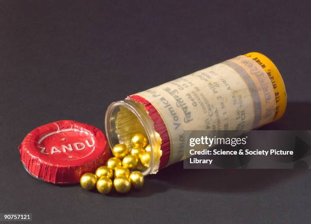 Plastic container of Nux Vomica powder pills covered in gold and used as an aphrodisiac by the Asian community in the United Kingdom. Made by Zandu...