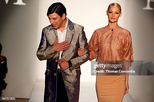 Designer Malan Breton and a model acknowledge the audience after the Malan Breton Spring 2010 collection during Style360 Fashion Week at the...