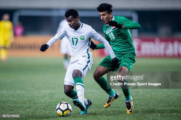 Abdullah Al Khaibari of Saudi Arabia fights for the ball with Amjed Attwan of Iraq during the AFC U23 Championship China 2018 Group C match between...