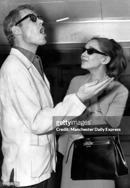 British actor Peter O'Toole flicks a cigarette towards his mouth while waiting to fly to Italy. He caught it first time.