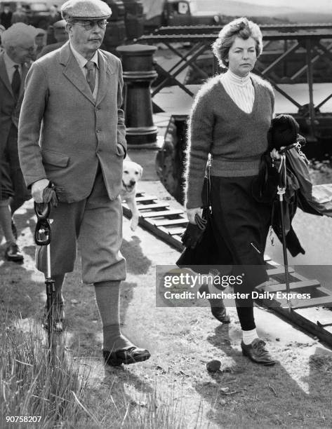 The Premier, Mr Macmillan, steps out for the shooting butts on Barden High Moor. With him is his hostess, the Duchess of Devonshire. Their party...