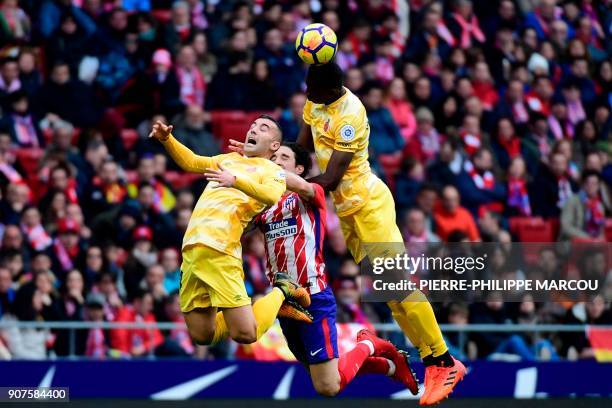 Girona's Spanish midfielder Borja Garcia and Girona's Kenyan forward Michael Olunga head the ball with Atletico Madrid's Croatian defender Sime...