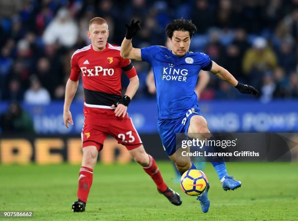 Shinji Okazaki of Leicester City is challenged by Ben Watson of Watford during the Premier League match between Leicester City and Watford at The...