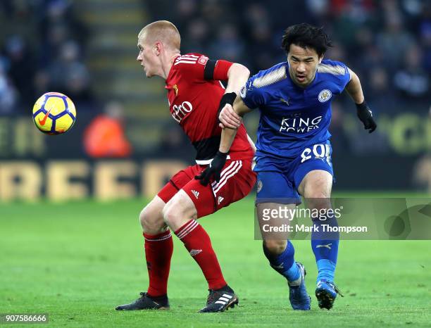 Shinji Okazaki of Leicester City is challenged by Ben Watson of Watford during the Premier League match between Leicester City and Watford at The...