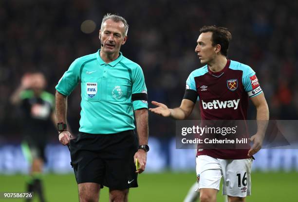 Mark Noble of West Ham United speaks with Match Referee, Martin Atkinson during the Premier League match between West Ham United and AFC Bournemouth...