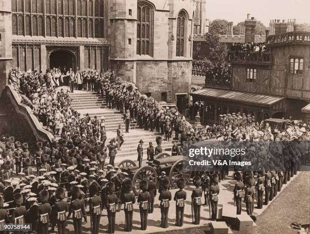 Photograph by Horace W Nicholls of the funeral of King Edward VII at St George's Chapel, Windsor. Officers salute as the coffin is carried to a gun...