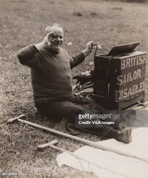 Photograph by Horace W Nicholls of a disabled British sailor begging at the famous horse race in Epsom, Surrey. "