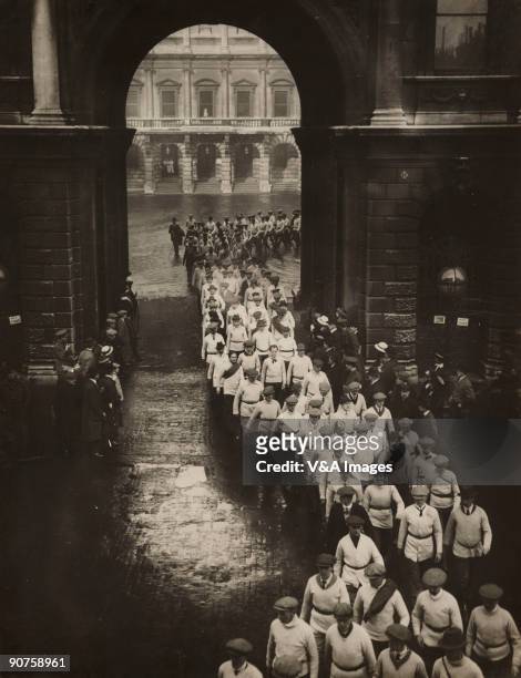 Gelatin silver print. Photograph by Horace W Nicholls of a procession of men filing out of the the Royal Academy of Arts at Burlington House in...