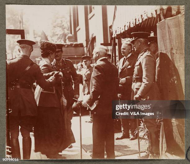 Printing out paper print. Photograph by Horace W Nicholls of the visit of King George V and Queen Mary to a factory manufacturing soldiers' uniforms.