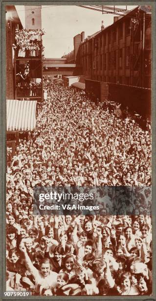 Printing out paper print. Photograph by Horace W Nicholls of the visit of King George V and Queen Mary to a factory manufacturing soldiers' uniforms.