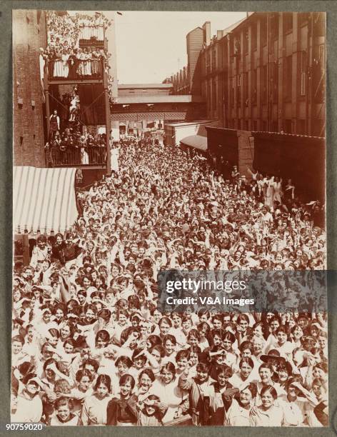 Photograph by Horace W Nicholls of the visit of King George V and Queen Mary to a factory manufacturing soldiers' uniforms.