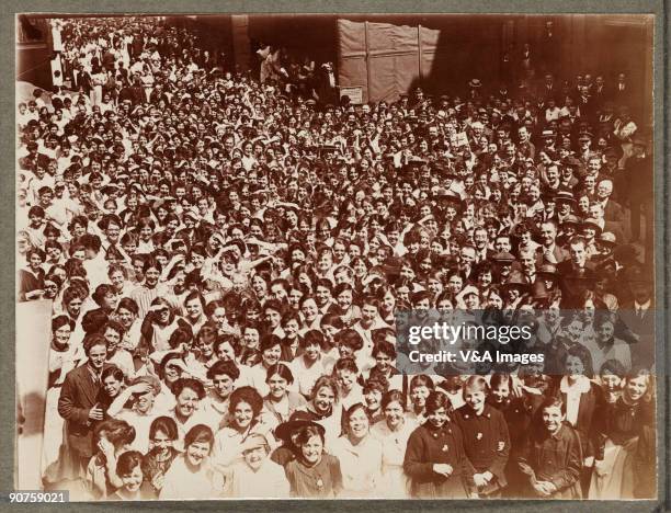 Printing out paper print. Photograph by Horace W Nicholls of the visit of King George V and Queen Mary to a factory manufacturing soldiers' uniforms.