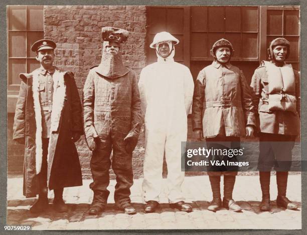 Printing out paper print. Photograph by Horace W Nicholls of the visit of King George V and Queen Mary to a factory manufacturing soldiers' uniforms.