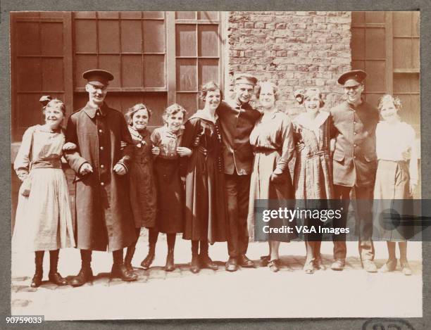 Printing out paper print. Photograph by Horace W Nicholls of the visit of King George V and Queen Mary to a factory manufacturing soldiers' uniforms.