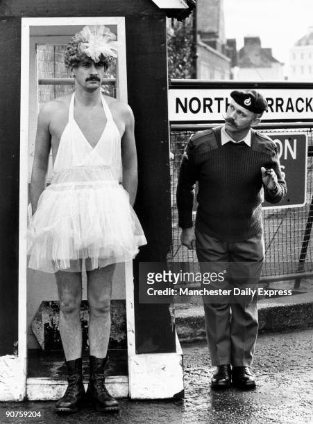 It ain�t half hot Sarge under this blond wig_and my skimpy tutu shows all my tattoos. Still, the rough, tough Royal Marines are used to going beyond...