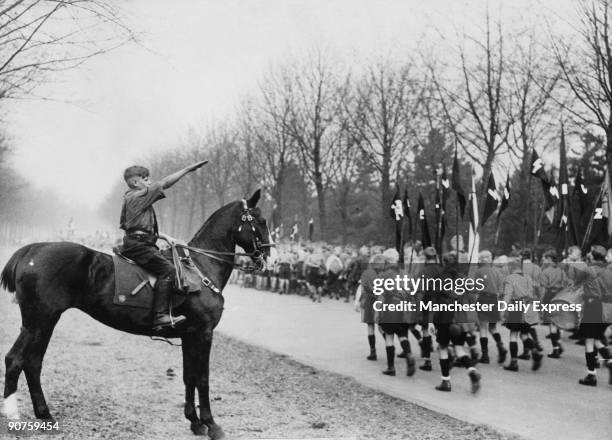 Young Hitlerian on horseback, taking the salute at the march-past of his young comrades at the Hitler Youth Movement in Hamburg?.