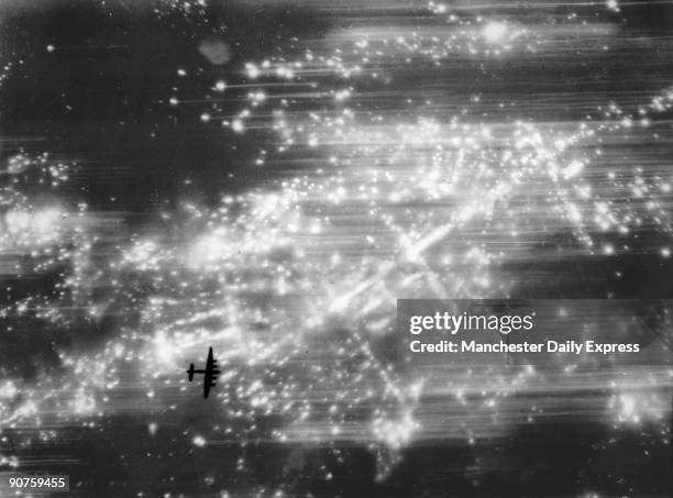 An RAF Lancaster bomber over the German city of Hamburg during a bombing raid.