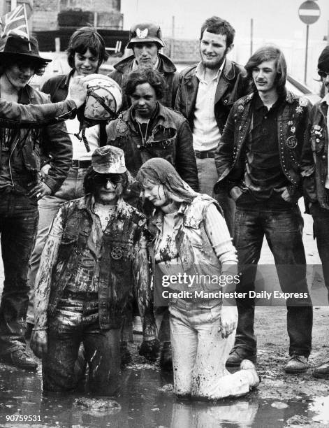 Newly-married Golly and Sugar are baptised by Scouse, watched by their biker friends.