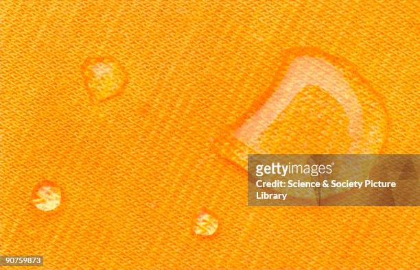 Water droplets on a nano-tech polo-neck jumper. Nano-sized treatments can give fabrics novel and useful properties. Synthetic materials draw moisture...