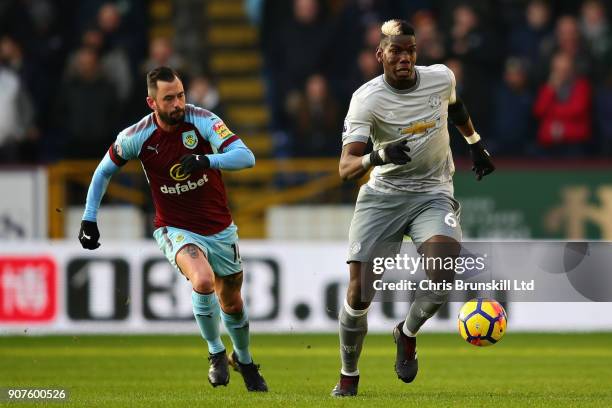 Paul Pogba of Manchester United is chased down by Steven Defour of Burnley during the Premier League match between Burnley and Manchester United at...